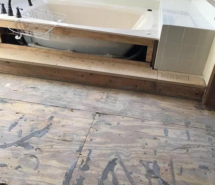 Bathtub with an exposed subfloor and tub sides