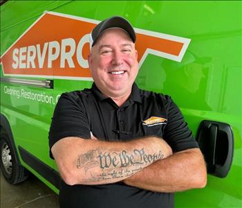 Man standing in front of servpro green vehicle
